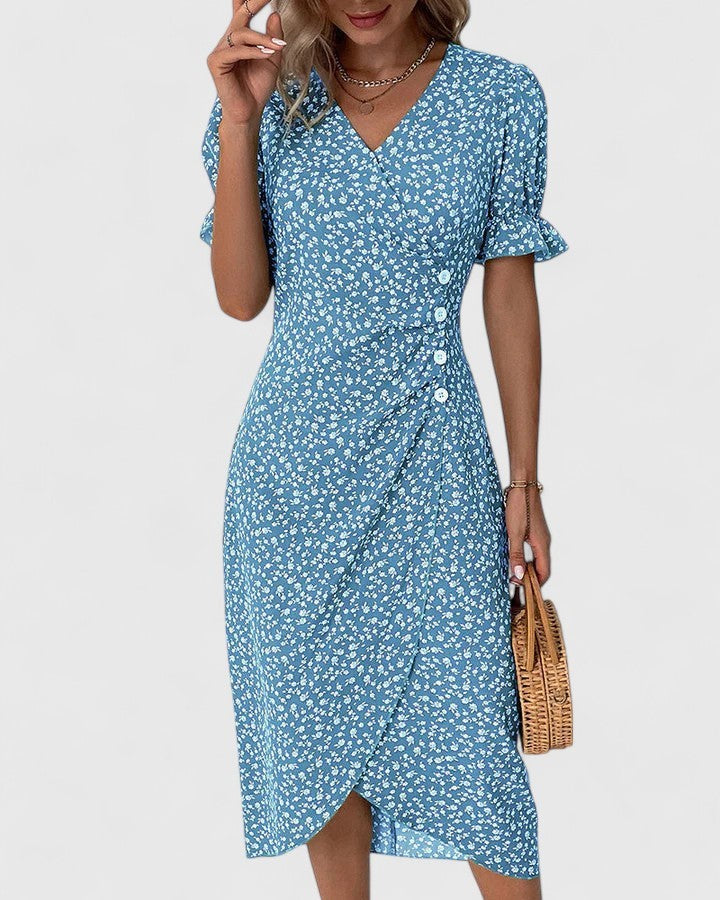Blue floral wrap dress paired with straw handbag and puff sleeves