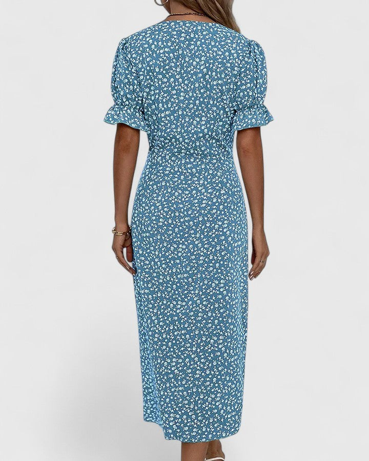 Back view of blue floral midi dress with ruffle sleeve detail