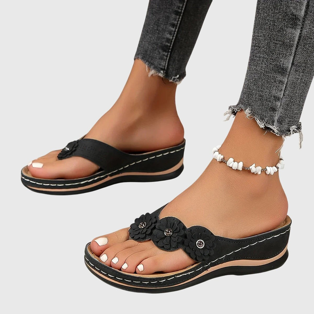 black flower-strap wedge sandals with cushioned platform sole