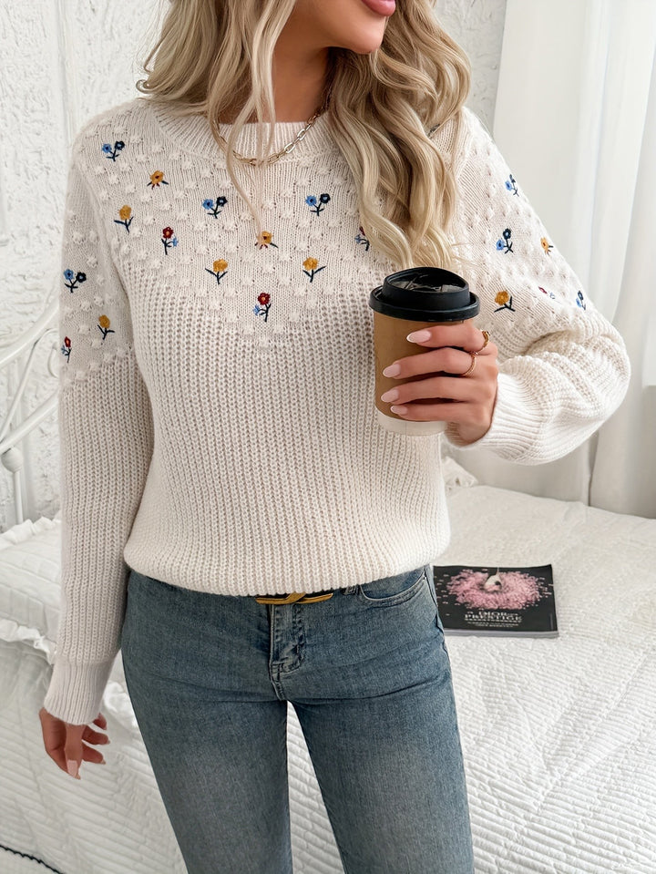 Cream embroidered knit jumper styled with denim and a gold chain necklace