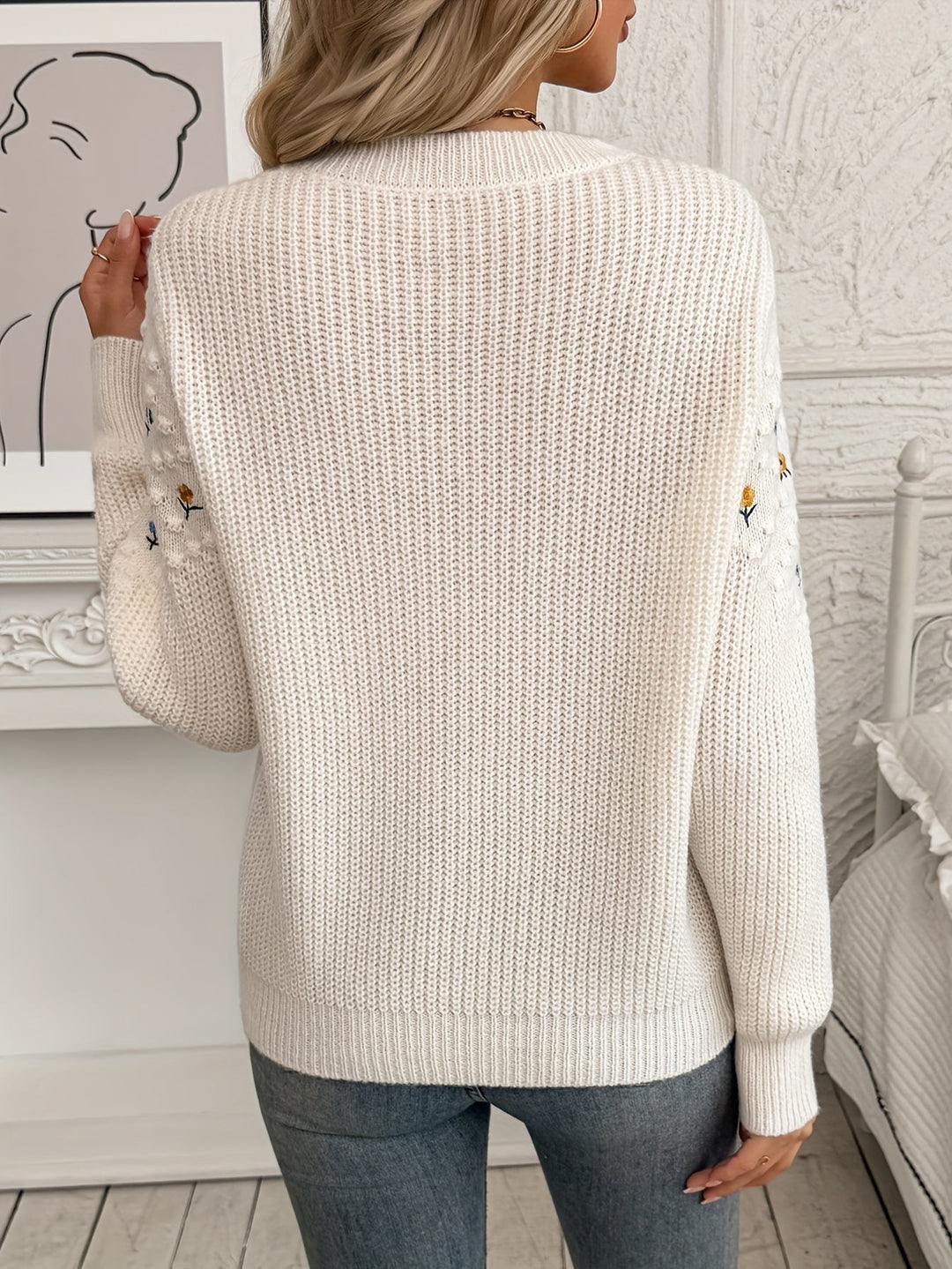 Back view of cream floral embroidered jumper showing ribbed knit texture