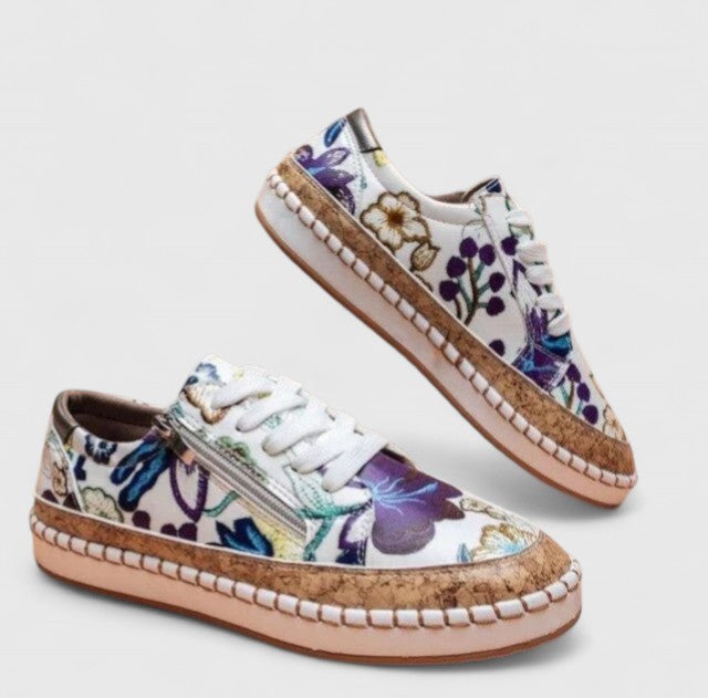 white floral embroidered sneakers with purple accents and cork sole trim