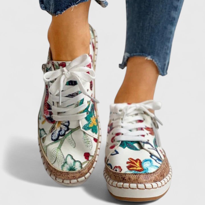 colorful floral canvas sneakers paired with denim and cork platform base