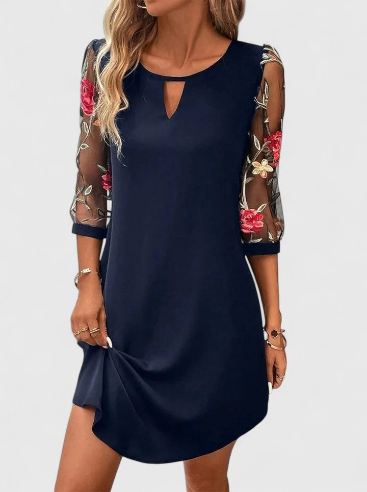 Navy shift dress with sheer floral embroidered sleeves and keyhole neckline