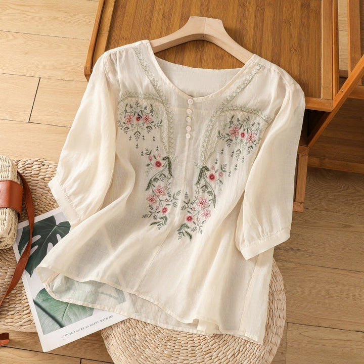 Cream floral embroidered blouse featuring button front and flowy half sleeves