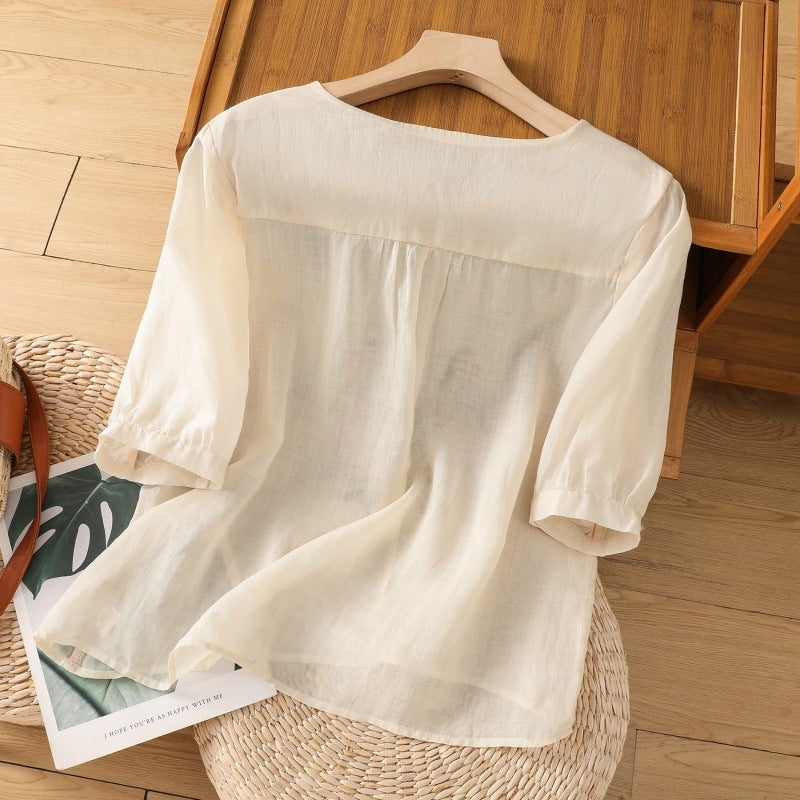 Back view of cream linen blouse showing relaxed fit and half sleeves