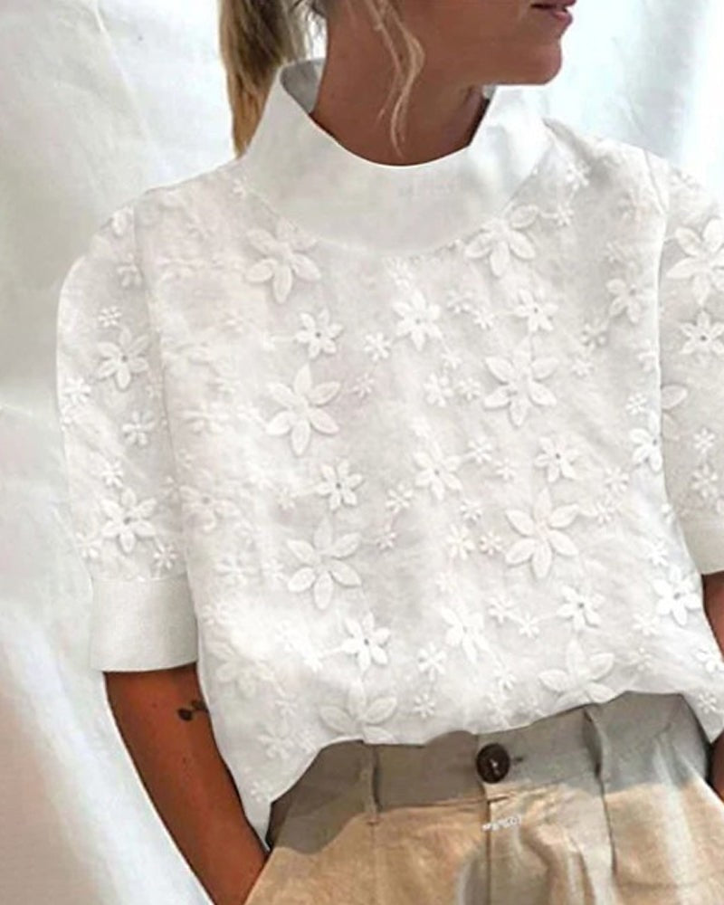Mock neck white top featuring textured floral embroidery detail