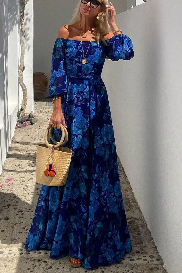 Off-shoulder blue floral maxi dress paired with a woven straw handbag