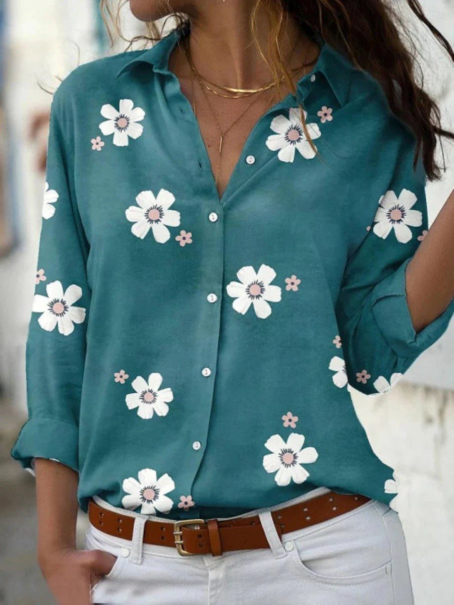 Teal floral print button-down blouse with white daisy pattern and rolled cuffs