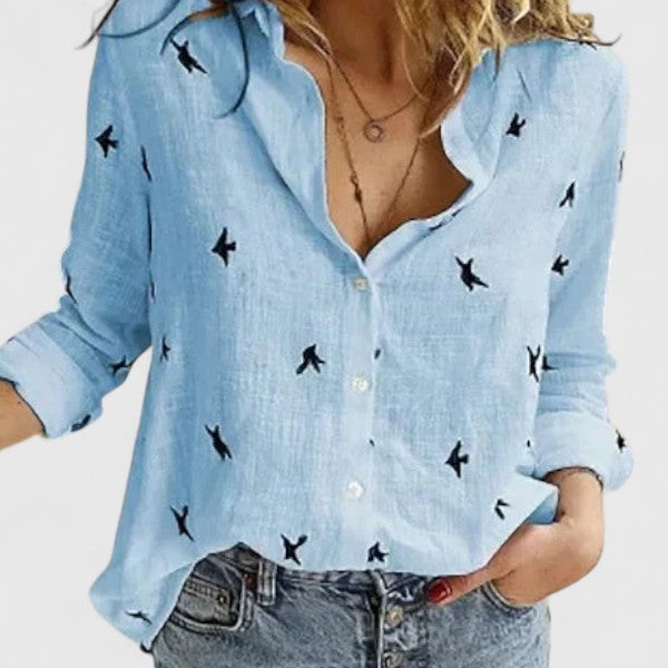 light blue bird print linen blouse with button-down front and rolled sleeves