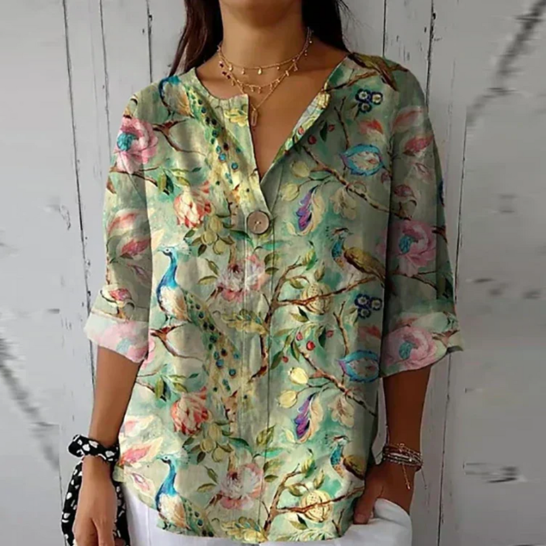 Peacock and floral print blouse in soft green with rolled sleeve cuffs
