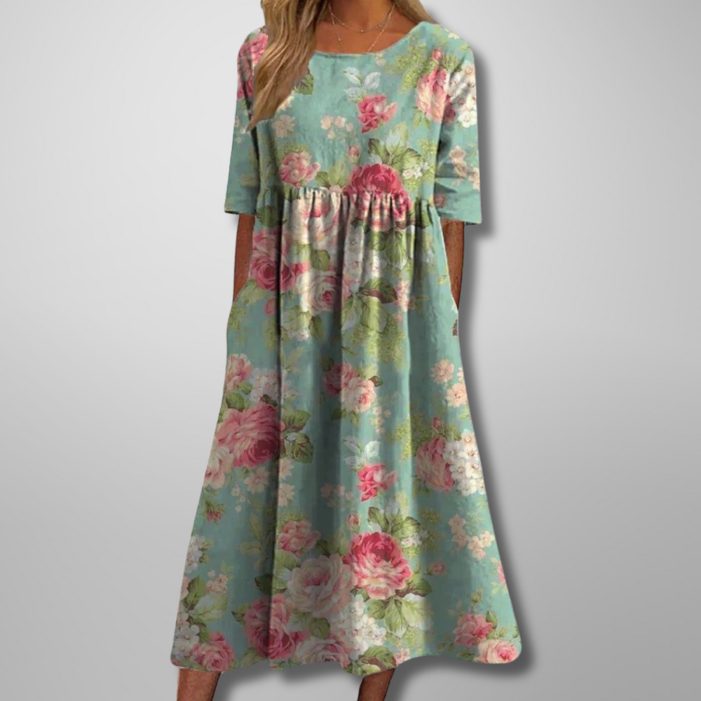 Sage green midi dress featuring pink rose print and relaxed A-line fit
