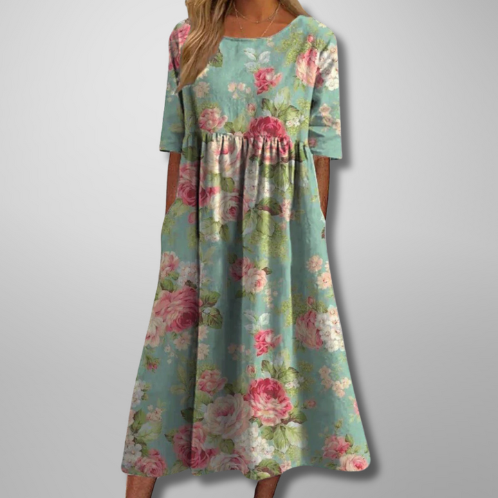 Sage green midi dress featuring pink rose print and relaxed A-line fit