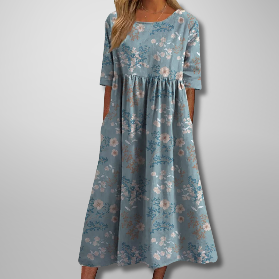 Dusty blue midi dress featuring small floral print and swingy silhouette