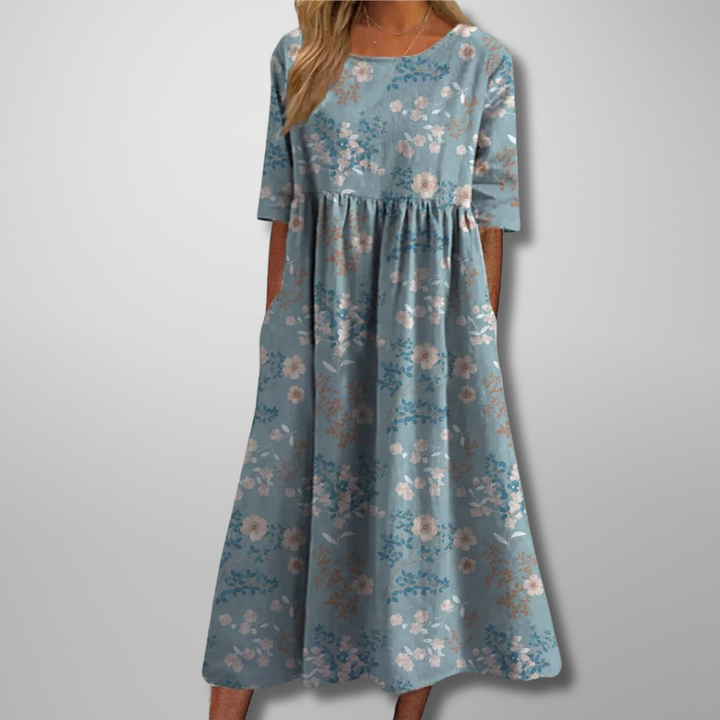 Dusty blue midi dress featuring small floral print and swingy silhouette