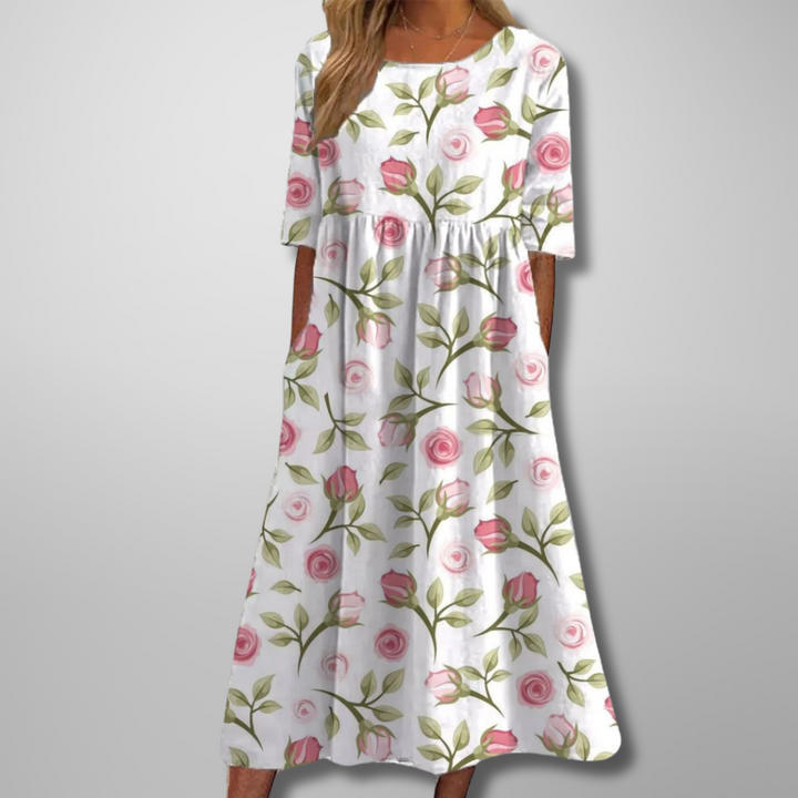 White midi dress featuring pink rose print and flowy A-line skirt