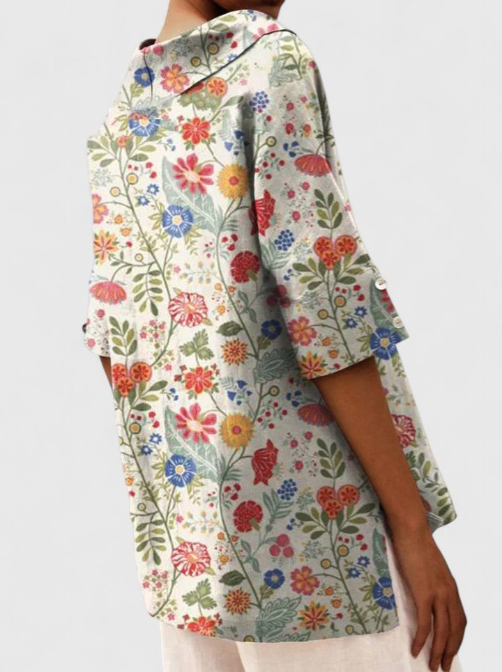 Side view of multicolor floral tunic showing hood and sleeve buttons