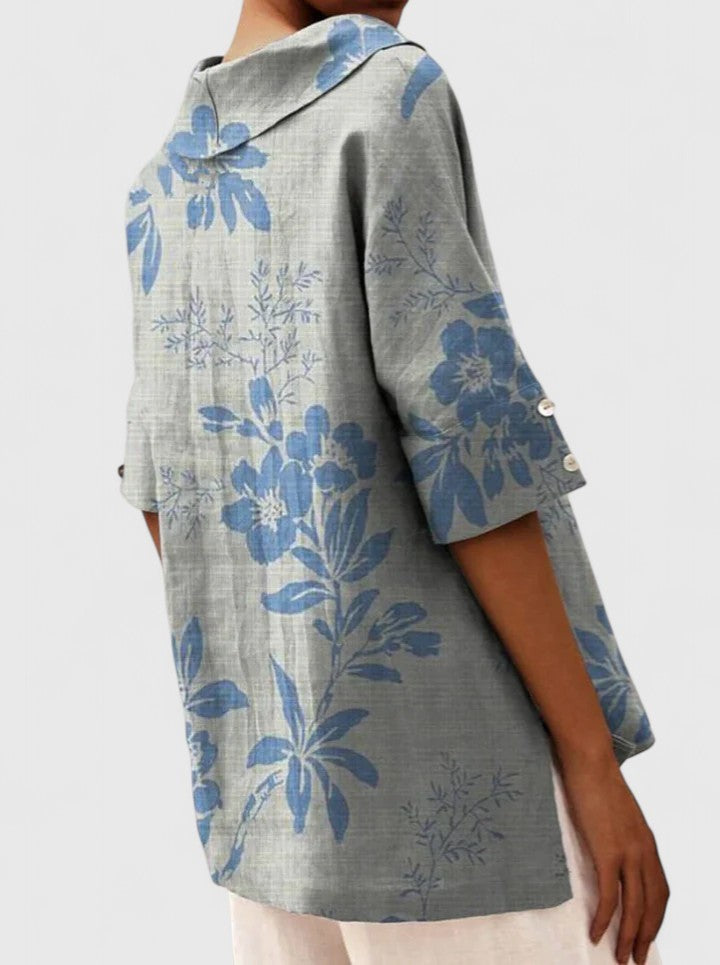 Back view of blue floral hooded tunic with button cuff detail