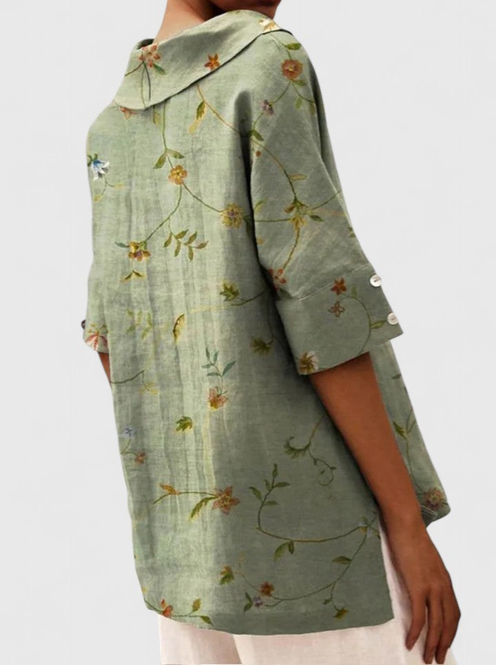 Back view of sage green floral hooded tunic with button cuffs