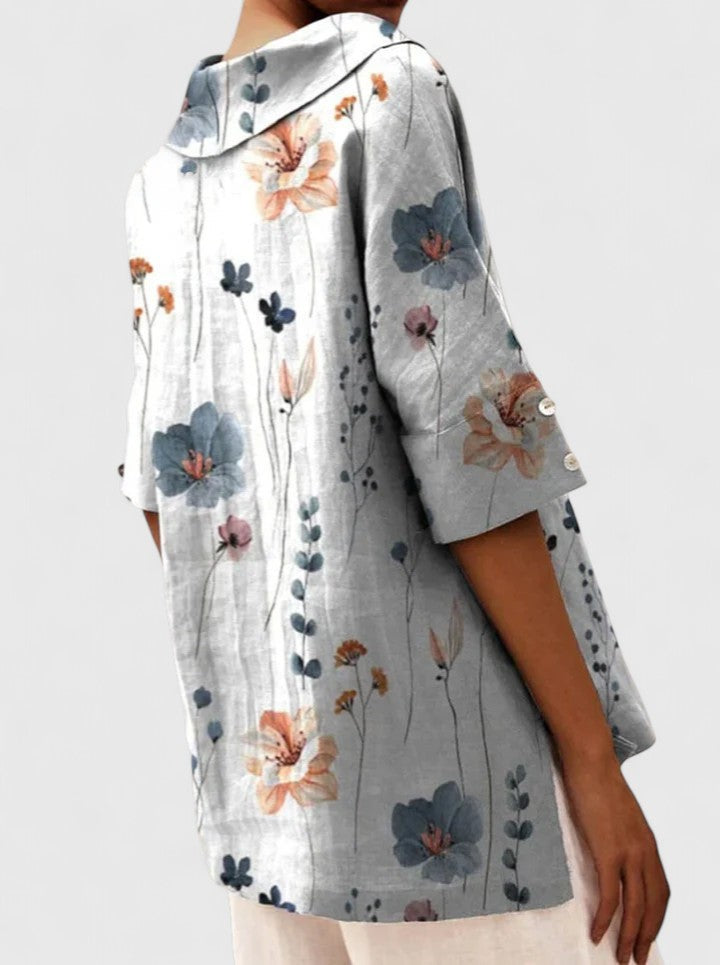 Side view of gray floral hooded tunic with buttoned half sleeves