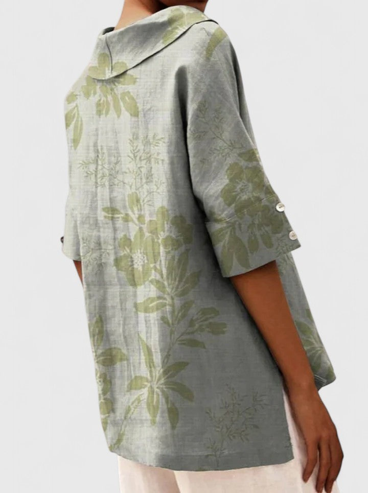 Back view of sage green leaf print tunic with buttoned cuffs