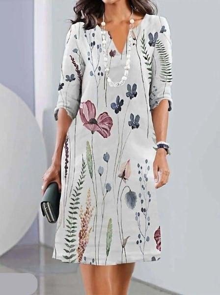 White botanical print tunic dress with three-quarter sleeves and V-neck