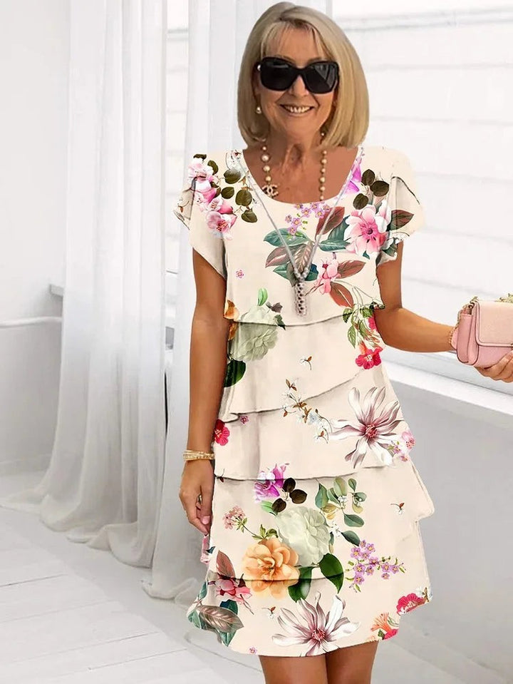Ivory floral tiered dress with ruffled layers and pastel flower print