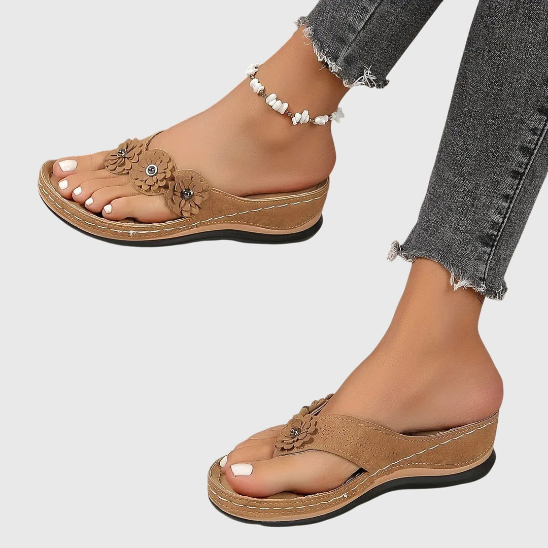 Camel suede wedge sandals showing triple flower toe-strap detail