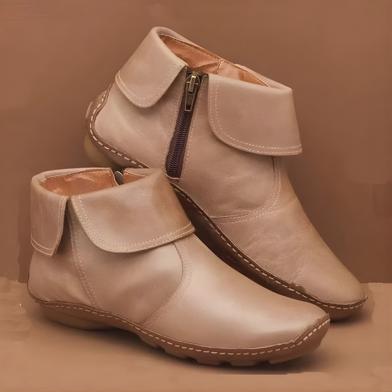 Cream leather ankle boots featuring turned-down collar and contrast stitching