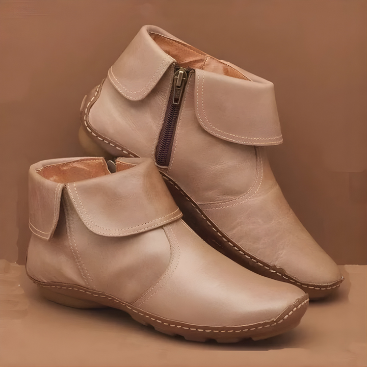 Cream leather ankle boots featuring turned-down collar and contrast stitching