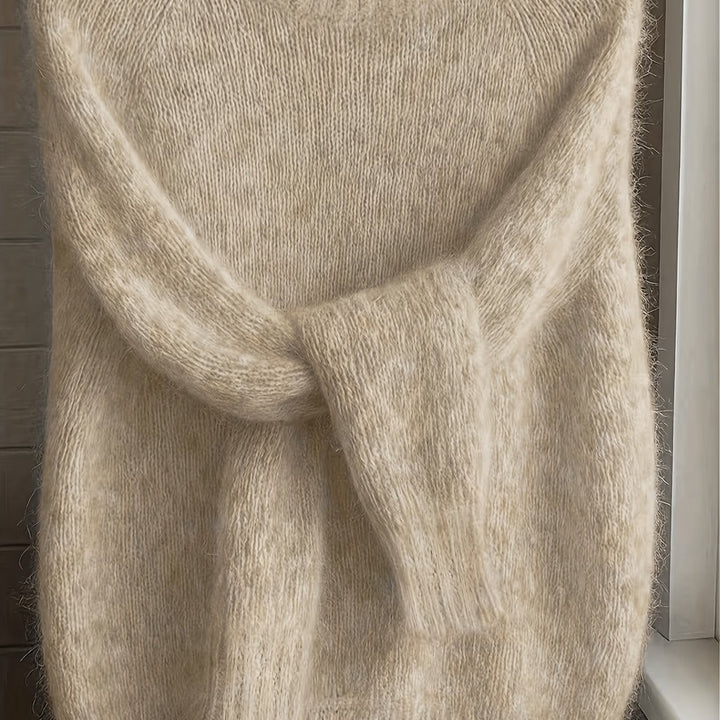 Close-up of beige fluffy knit jumper with ribbed cuffs and soft texture