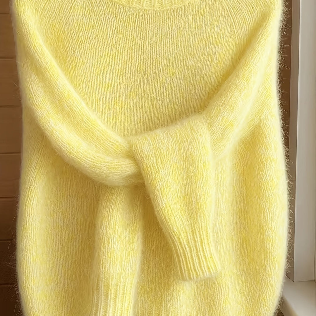 Close-up of pale yellow fuzzy knit jumper with ribbed sleeve detail