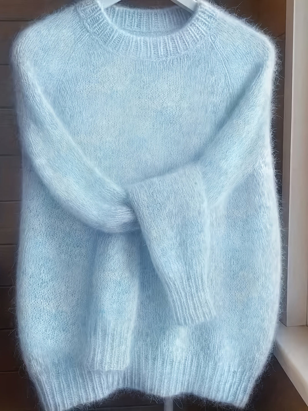 Pale blue fluffy knit jumper with ribbed crew neck and cuffs