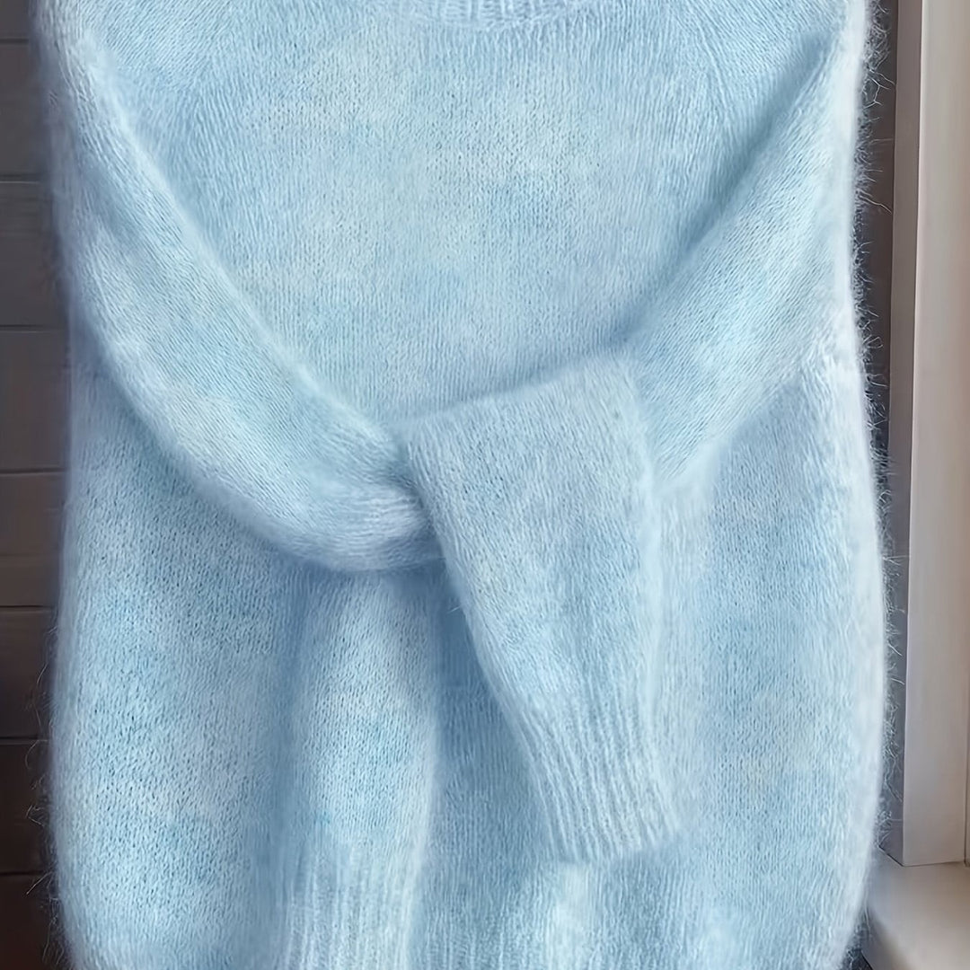 Close-up of pale blue fuzzy knit jumper showing soft ribbed sleeves