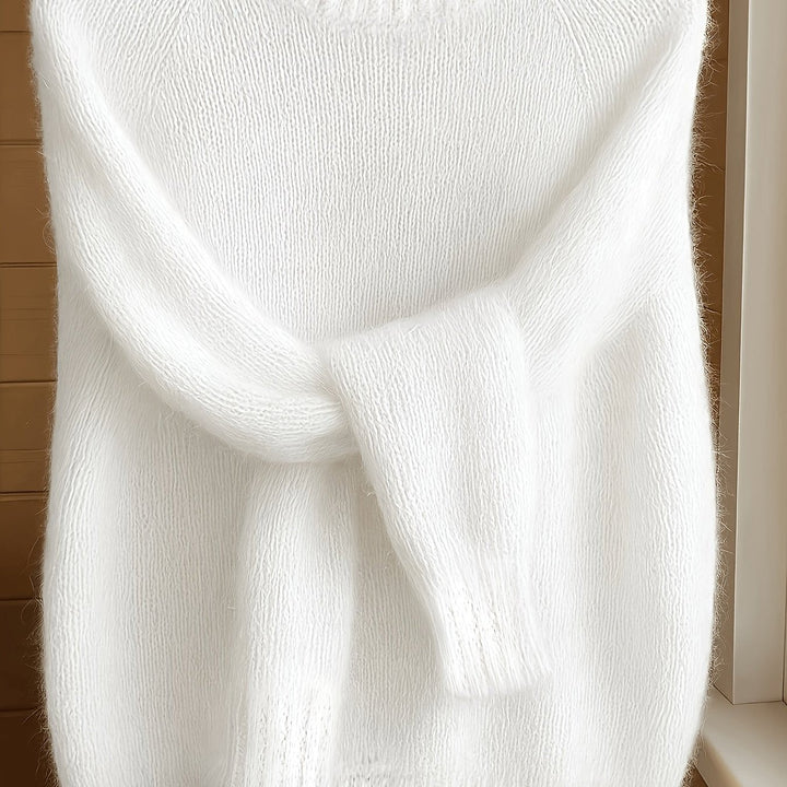 Close-up of white fluffy knit jumper highlighting textured mohair-style yarn