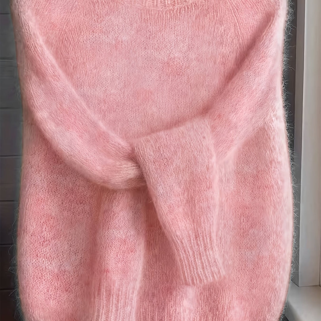 Close-up of pink fuzzy knit jumper showing soft folded sleeve detail