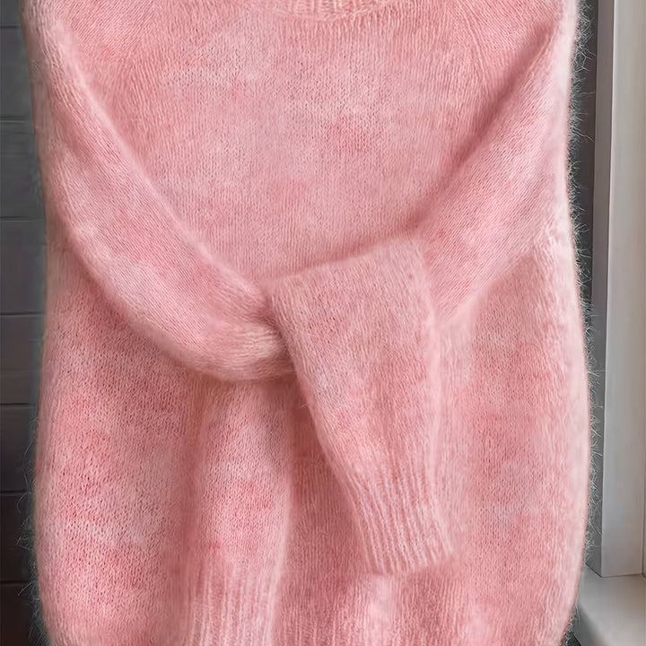 Close-up of pink fuzzy knit jumper showing soft folded sleeve detail