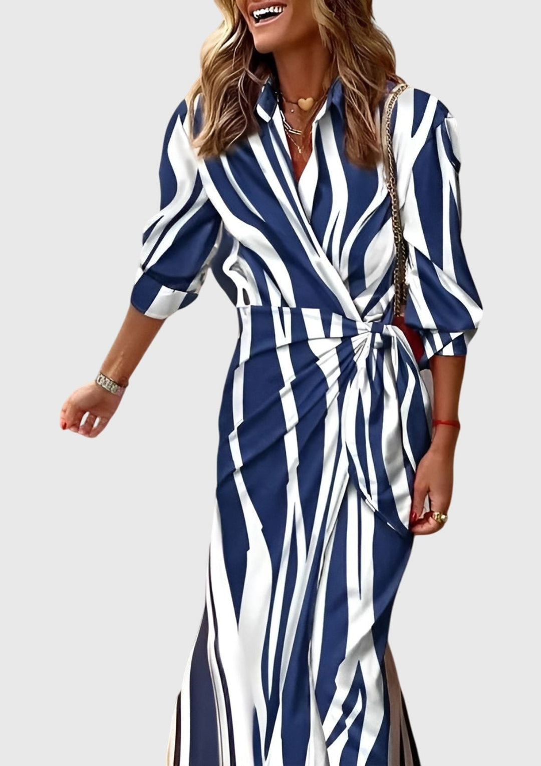 Navy and white striped wrap dress with three-quarter sleeves and side tie
