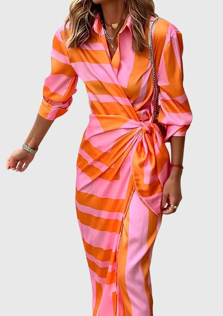 Long sleeve wrap dress in pink and orange print with draped waist tie