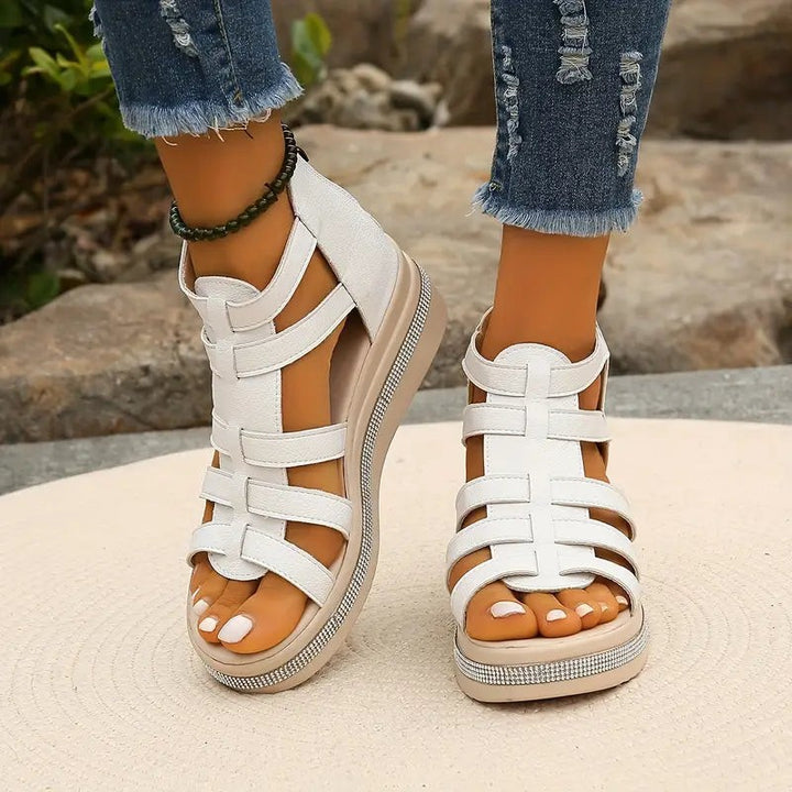 white caged wedge sandals with multi-strap front and glittery sole trim