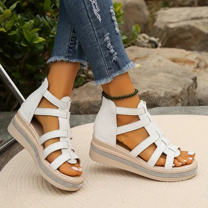 white gladiator wedge sandals with zip closure and rhinestone platform detail