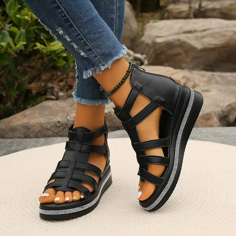 black strappy wedge sandals featuring caged design and sparkly sole detail
