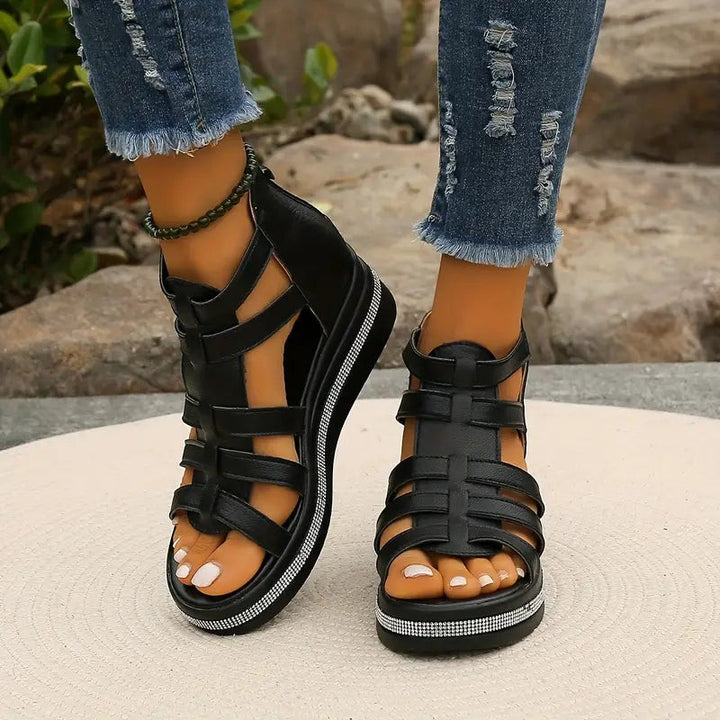 black gladiator sandals with zip-back heel and rhinestone-studded sole