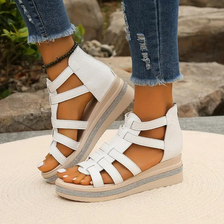 beige gladiator wedge sandals with multi-strap design and rhinestone trim