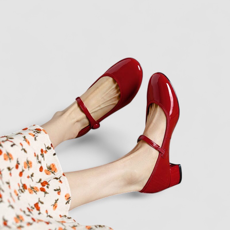 Red patent leather Mary Jane pumps with buckled ankle strap
