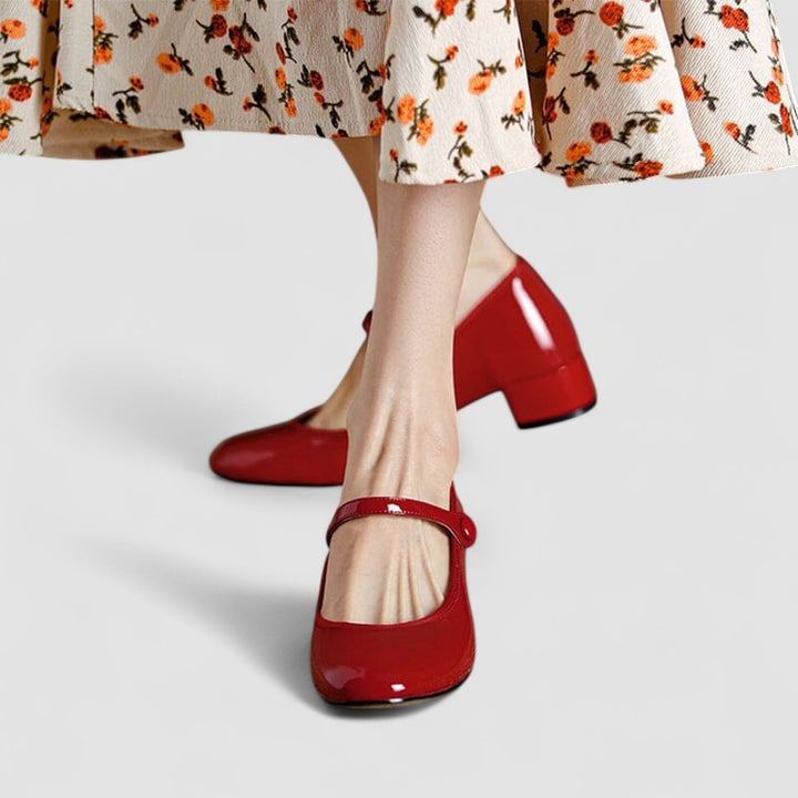 Cherry red patent Mary Jane flats worn with floral midi dress
