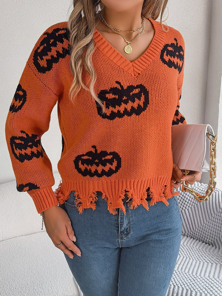 Orange knit sweater featuring black Halloween pumpkin faces and distressed trim