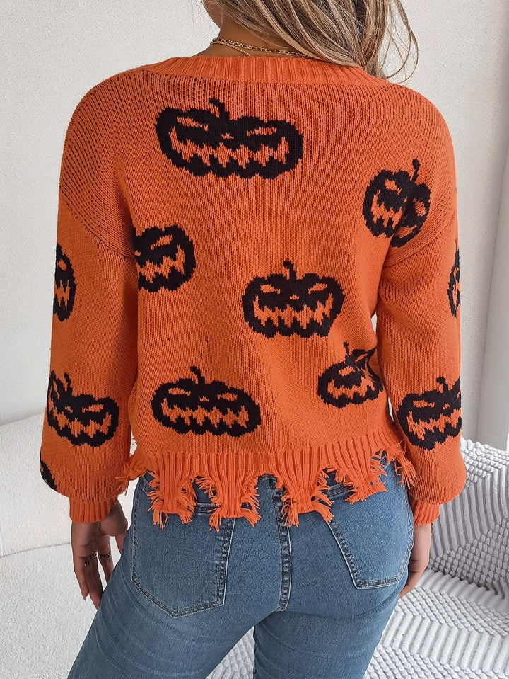 Back view of orange pumpkin print sweater showing frayed knit hemline