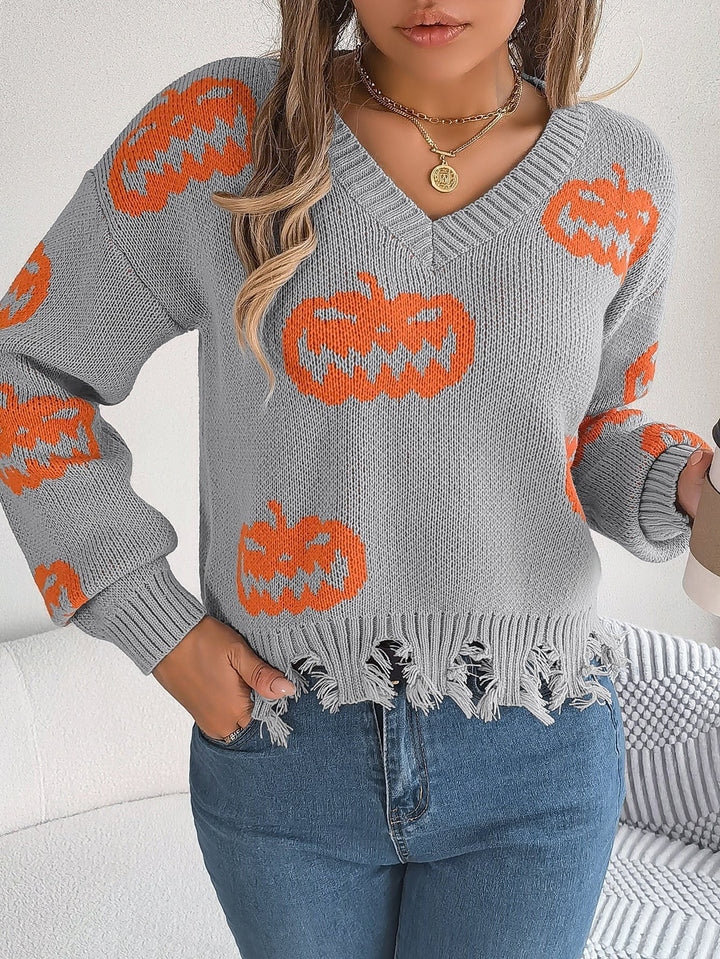 Black V-neck sweater with orange jack-o'-lantern print and raw hem