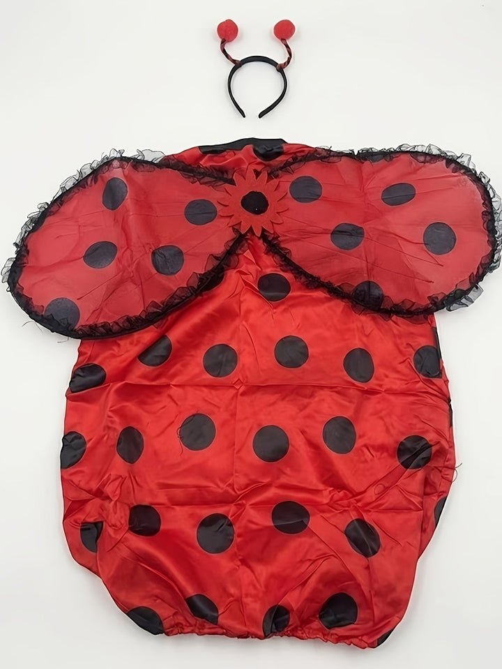 flat lay of ladybug costume dress with wing cape and antenna headband